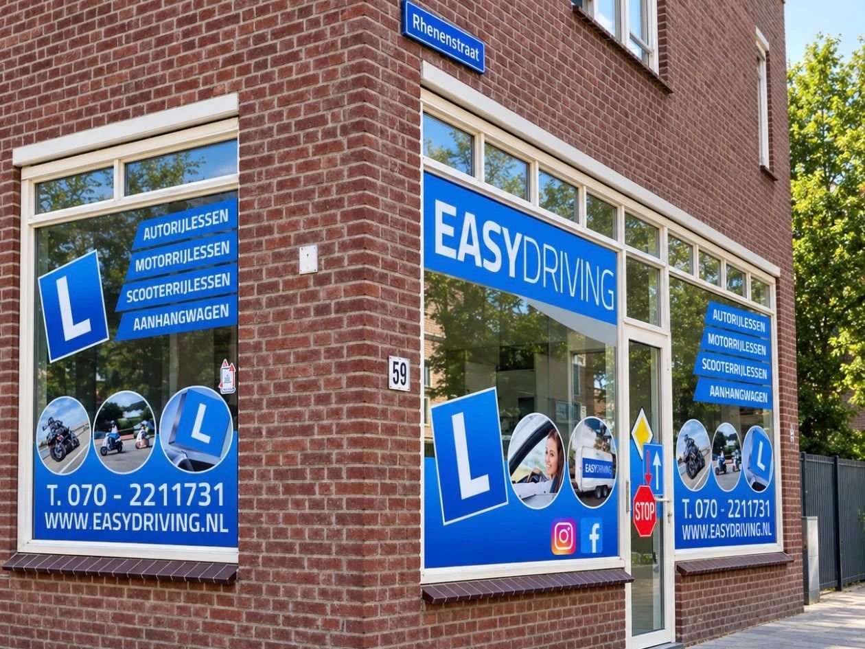 De gevel van Rijschool Easydriving op de hoek van de Rhenenstraat, met blauwe raambelettering voor autorijlessen, motorrijlessen, scooterrijlessen en aanhangwagen
